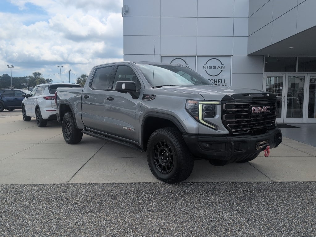 2023 GMC Sierra AT4X in Sterling Metallic — front three-quarter view