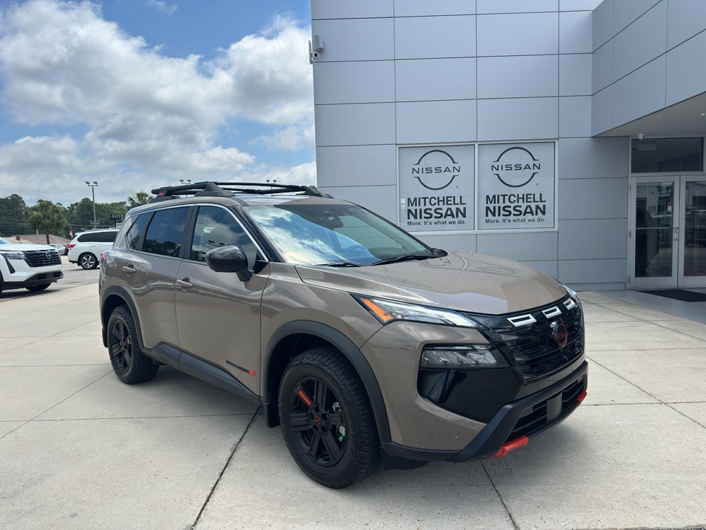 2025 Nissan Rogue Rock Creek in Baja Storm Metallic — front three-quarter view